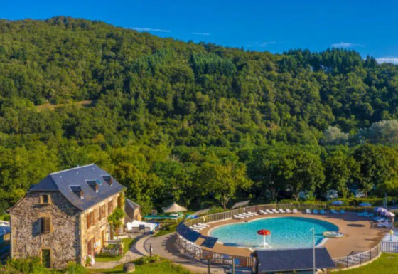 Villaggio turistico Seasonova Camping Les Rives d'Olt et Aubrac in Occitania, Francia, con piscina e colline.