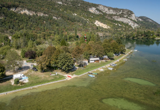Aerial view of Camping Seasonova Sous le Moulin, lakeside holiday park in Bourgogne-Franche-Comté, France.