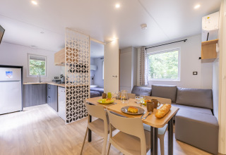Modern premium mobile home at Seasonova Camping Le Val de Coise, France, with kitchen, dining, and living area.