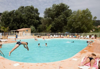 People enjoying a sunny day by the pool at Seasonova Camping Les Prés du Verdon in Provence-Alpes-Côte d’Azur, France.