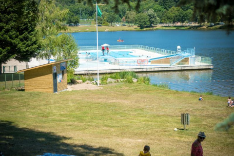 Floating swimming pool on a lake at Camping Paradis Les Chanterelles, Auvergne-Rhône-Alpes, France.