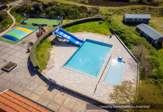 Aerial view of the pool, waterslide, playground and cabins at Camping Loodsmansduin, North Holland, Netherlands.