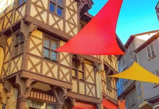 Casa a graticcio con vele colorate in una pittoresca via vicino a Bassemberg, Grand Est, Francia.