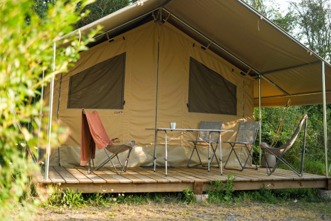Safari-Zelt Ponza mit Veranda und Campingstühlen bei Onlycamp Camping Les Thézières in Frankreich.