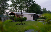 Terrace Lodge with sauna and hot tub at Holiday center 't Schuttenbelt, surrounded by lush greenery.