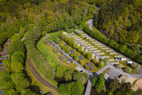 Aerial view of the Safari Tent at Hameau de l'Ourthe, Belgium, surrounded by green forest and nature.