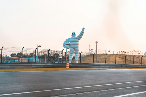 A large Michelin Man statue next to a racetrack near Saint-Rémy-sur-Durolle, Auvergne-Rhône-Alpes, France.