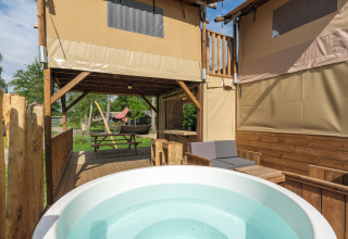 Treehouse tent with bubble tub at Holiday park Mölke in the Netherlands, cozy outdoor relaxation spot.