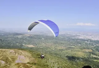 Paraglider soaring above the landscapes near Saint Yrieix sur Charente, Nouvelle-Aquitaine, France.