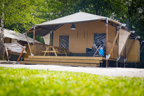 Safari-cottage telt ved Holiday Park Sallandshoeve i Holland med hængekøje, bord og grill foran.