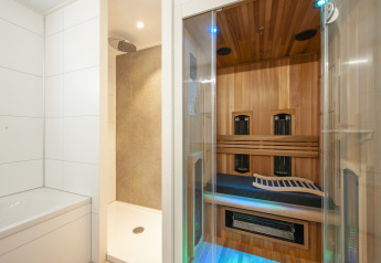 Moderne badeværelse med badekar, bruseniche og infrarød sauna i en Lodge Wellness 4 i Nederlandene