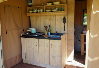 Petite cuisine sous tente safari à Arden Parks - Signy l'Abbaye, France, avec placards et évier en bois.