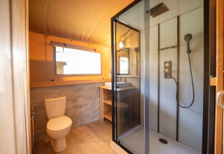 Bagno della tenda Safari 8 a Lauwersmeer, Paesi Bassi, con doccia, WC e lavabo moderno.