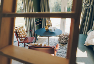 Modern living area in Koya Tiny Loft at Wilsumer Berge, Germany, viewed through a wooden ladder.