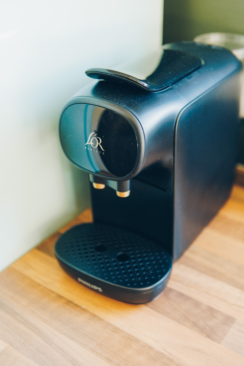 Coffee machine on wooden counter in Koya Tiny Loft, Wilsumer Berge, Germany, ideal for tiny homes.