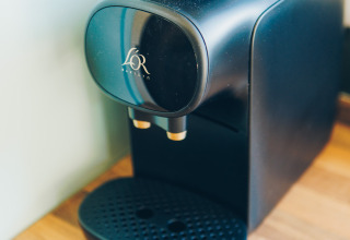 Coffee machine on wooden counter in Koya Tiny Loft, Wilsumer Berge, Germany, ideal for tiny homes.
