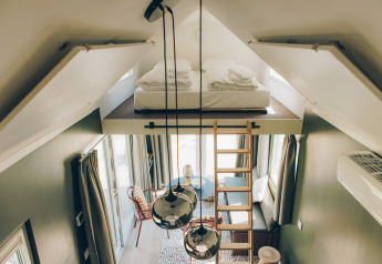 Interior view of Koya Tiny Loft featuring a lofted bed, ladder, and modern decor at Wilsumer Berge, Germany.