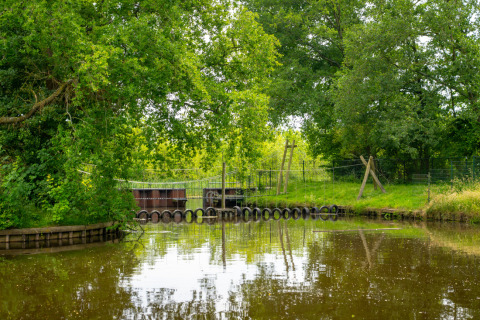 Lago circondato da verde e percorso a ostacoli a Hunzepark, parco vacanze a Drenthe, Paesi Bassi.