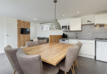 Moderne spise- og opholdsområde med køkken i Chalet Comfort 6 på Hunzepark, Nederlandene.