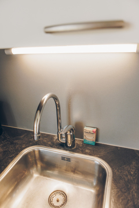Modern kitchen sink with sleek faucet, HappySoaps bar, and LED lighting in Valleichalet at Ackersate park.