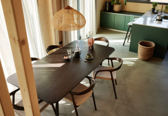 Modern dining and kitchen area at Unbrick One | Sauna and Pool at Brinckerduyn, Netherlands, with sunlight.