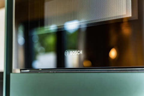 Close-up of a Bosch oven door at Unbrick One lodge with sauna and pool in Brinckerduyn, Netherlands.