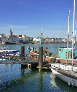 Boats docked in a marina near Saint Julien des Landes, Pays de la Loire, France, on a bright sunny day.