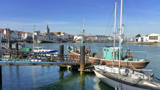 Boats docked in a marina near Saint Julien des Landes, Pays de la Loire, France, on a bright sunny day.