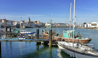 Boats docked in a marina near Saint Julien des Landes, Pays de la Loire, France, on a bright sunny day.