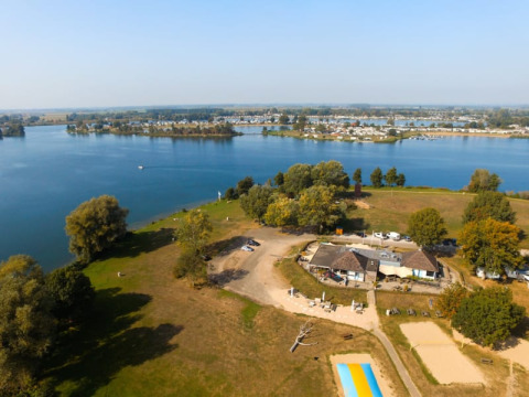 Luftaufnahme eines Safari-Zeltes mit sanitären Anlagen im Recreatiepark Riverside an einem See in den Niederlanden.
