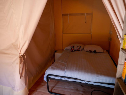 Interior view of Safari tent with private bathroom at Recreatiepark de Wrange in the Netherlands.