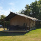 Safari-telt på Camping Eefting i Holland med veranda, udendørs stole og grønne træer i baggrunden.