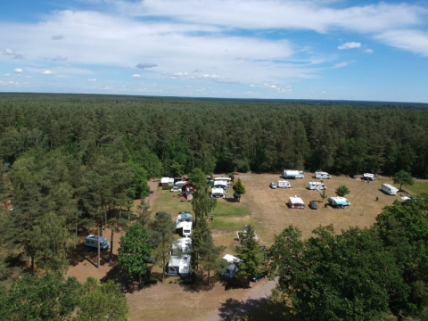 Luftaufnahme des Safari-Zelts auf Camping Sonnenberg in Deutschland, umgeben von Wald und Wohnwagen.