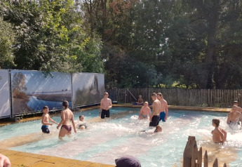 Mensen genieten van het openluchtzwembad bij de safaritent op Camping Elbeling in Duitsland.