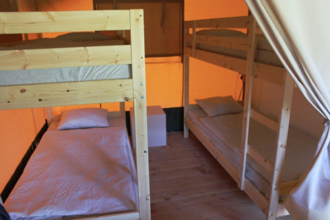 Binnenkant van een safaritent met stapelbedden bij Camping Prima in Tsjechië, gezellig ingericht.
