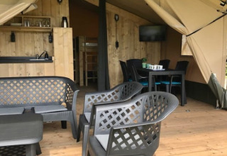 Safari-Zelt mit Terrasse, Sitzbereich und Küche auf dem Campingplatz de Zwammenberg in den Niederlanden.
