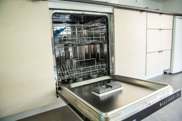 Dishwasher with open door in a modern kitchen at Sun Lodge, Camping Les Bouleaux in France.