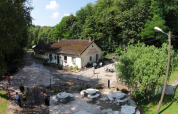 Aerial view of Camping Les Bouleaux holiday park in Grand Est, France, surrounded by forest and outdoor seating.