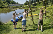 Ragazzi trasportano una zattera in acqua Camping Donnersberg a Gerbach, Renania-Palatinato, Germania