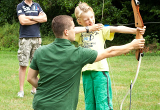 Youngster learns archery Camping Donnersberg in Gerbach, Rheinland-Pfalz, Germany
