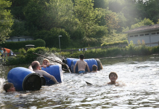 Children playing with rafts in the water Camping Donnersberg in Gerbach