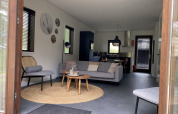 Interior view of a modern lodge at Modus, Bad Hoophuizen, Netherlands, featuring a stylish living area.