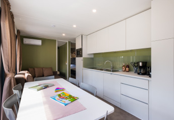 Modern family lodge kitchen and dining area at Cottage Next XXL Family Deluxe, Papillon Country Resort, Netherlands.