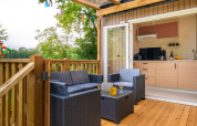 Outdoor terrace and modern kitchen view at Cottage Next XL in Papillon Country Resort, Netherlands.