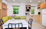 Modern kitchen and dining area in Cottage Next XXL Family, Papillon Country Resort, Netherlands, with nature view.