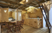 Interior view of Airlodge 2.0 Family Hottub at Papillon Country Resort, Netherlands, with rustic wooden furniture.