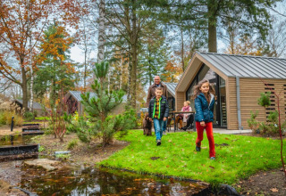 Family walking by accommodation - EuroParcs De Hooge Veluwe - Arnhem, Gelderland, Netherlands