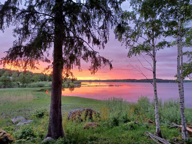 Coucher de soleil à Camping Falkudden, Dalarna, Suède, avec lac paisible, arbres et couleurs éclatantes.