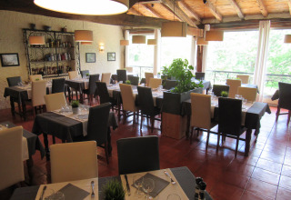 Lyst og hyggeligt restaurantinteriør hos Le Camp de Florence feriepark i Occitanie, Frankrig.