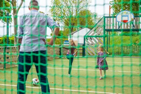 Father plays soccer with two daughters - EuroParcs Gulperberg - Gulpen, Limburg, Netherlands
